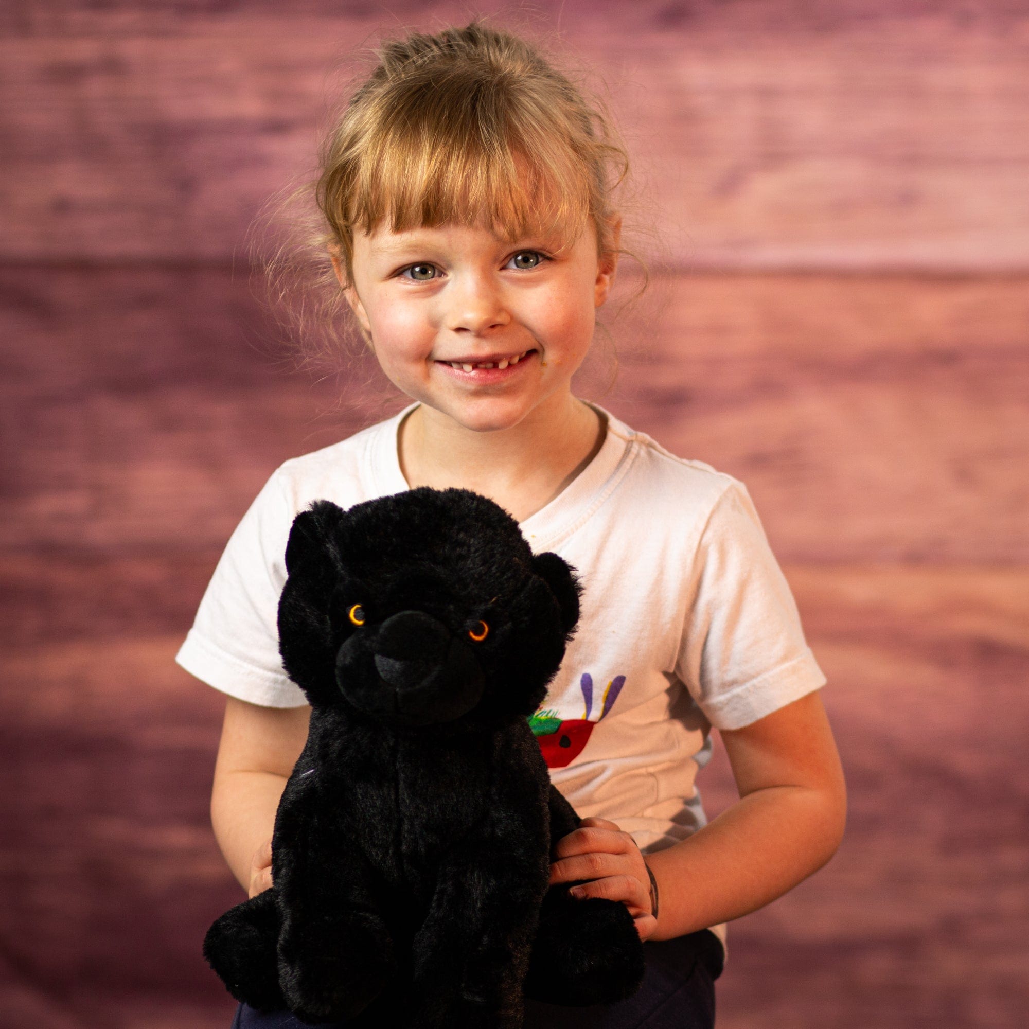 girl holding 10 in stuffed black panther