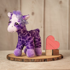 12 inch  tall purple giraffe with a purple bow and eyelashes