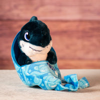 stuffed blue shark in swaddle