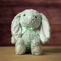 16 in stuffed green bunny wearing a bow and has striped ears 