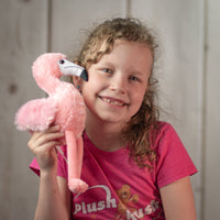girl holding stuffed 8" Pink Flamingo with a white beak