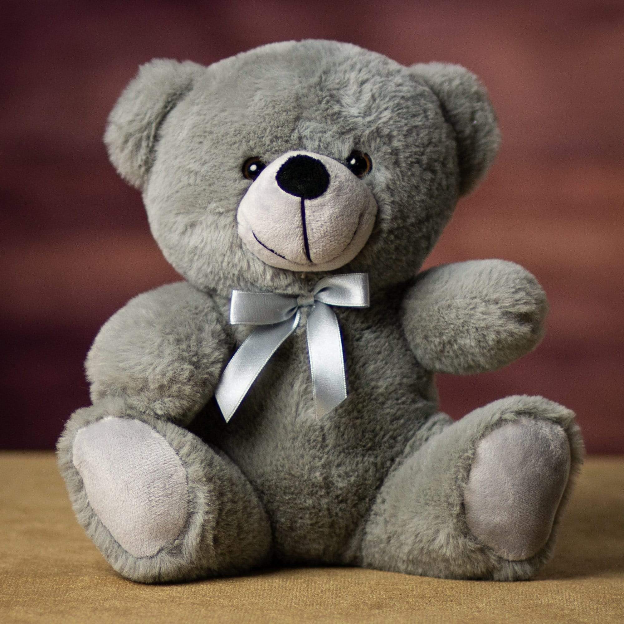 A gray bear that is 9 inches tall while sitting