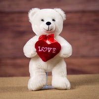 A standing white bear that is 8 inches tall while sitting holding a red Love heart