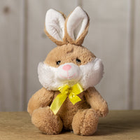 A beige rabbit that is 10 inches while sitting wearing a yellow bow