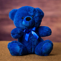 A blue bear that is 9 inches tall while sitting