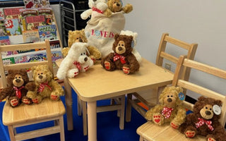 Brides by Elizabeth staff member holds a box of donated teddy bears for local police officers.