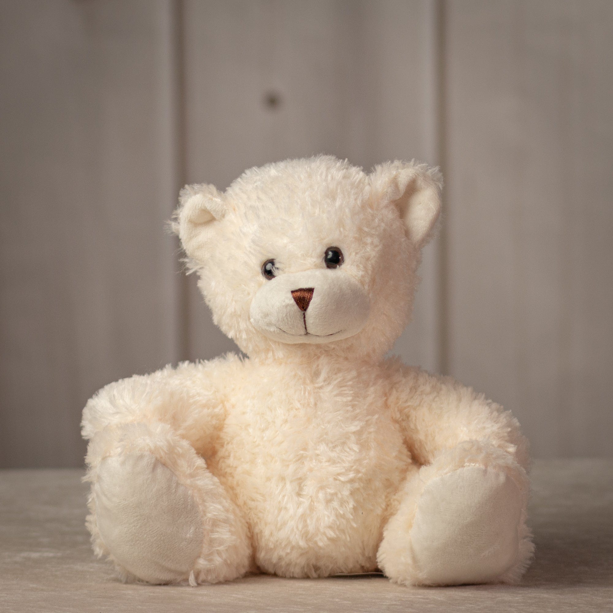 10 inch sitting cream colored stuffed teddy bear