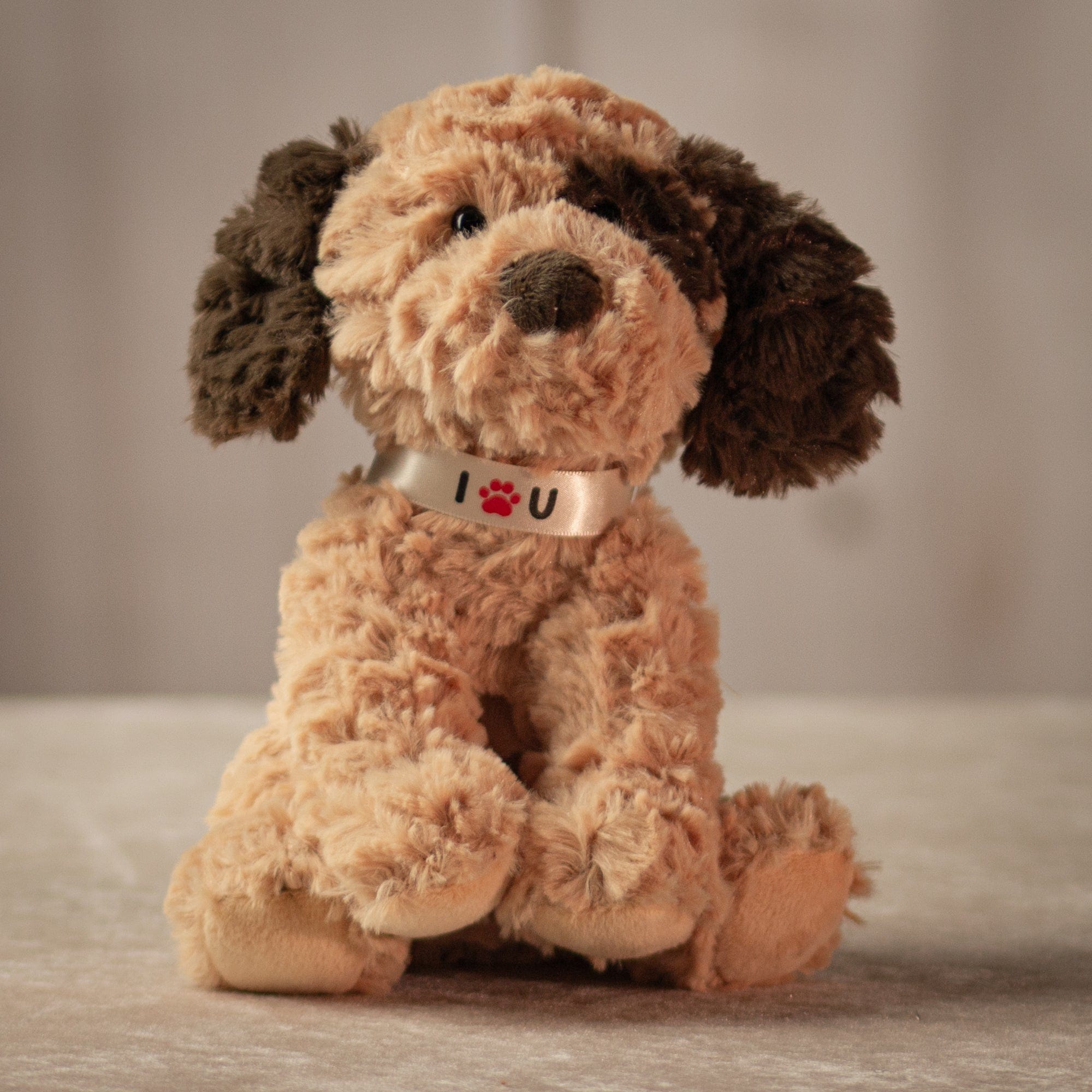 8 inch stuffed beige puppy with a ribbon that says "I love you" around its neck