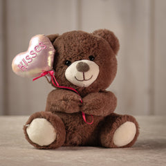 9 inch brown stuffed bear holding a balloon that says "kisses"