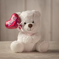 9 inch white stuffed bear holding a balloon that says "xoxo"
