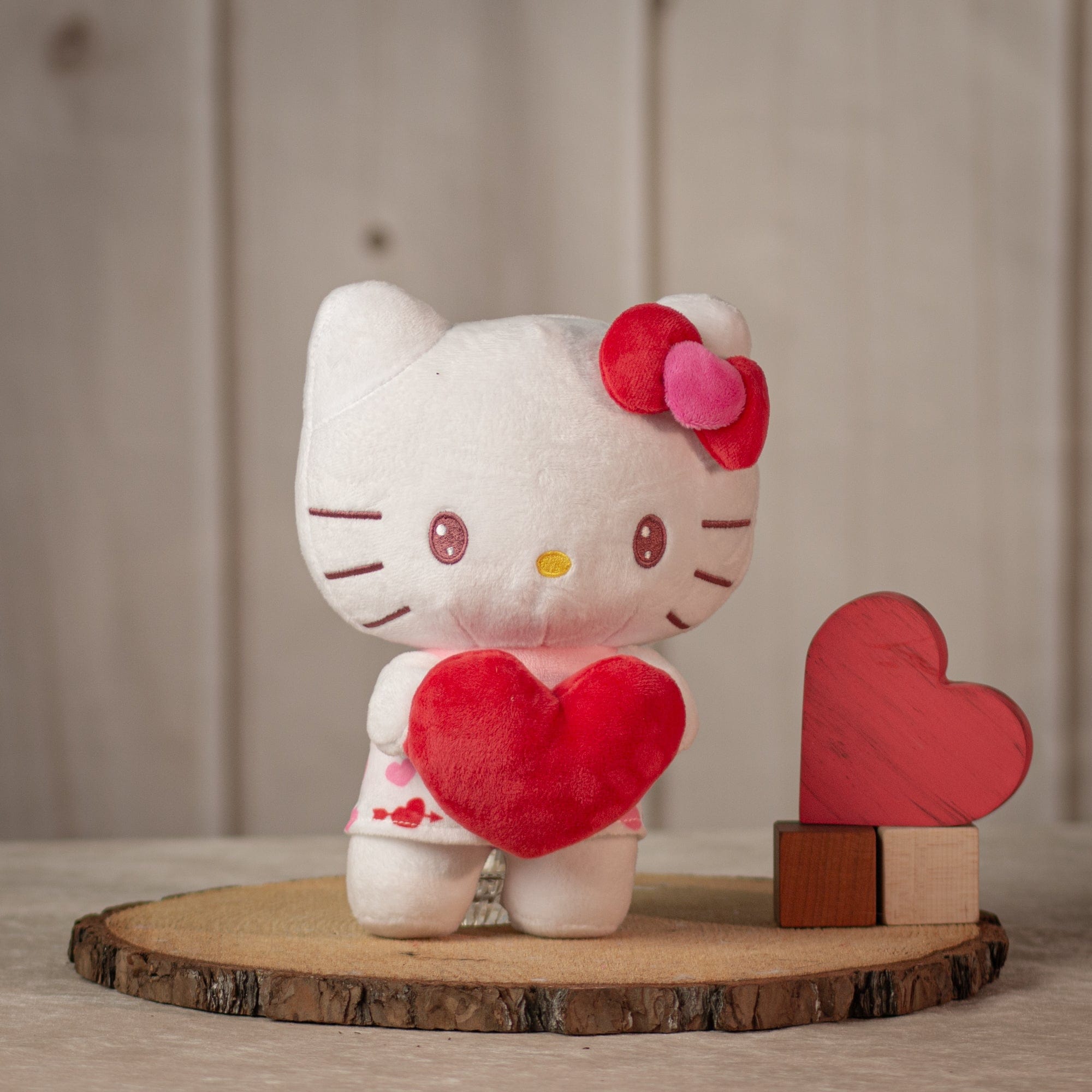 9 inch Valentine Hello Kitty with a red bow holding a stuffed red heart