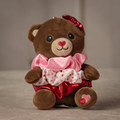 6" stuffed brown bear keychain with three Valentine's designed hair scrunchies tied around its body