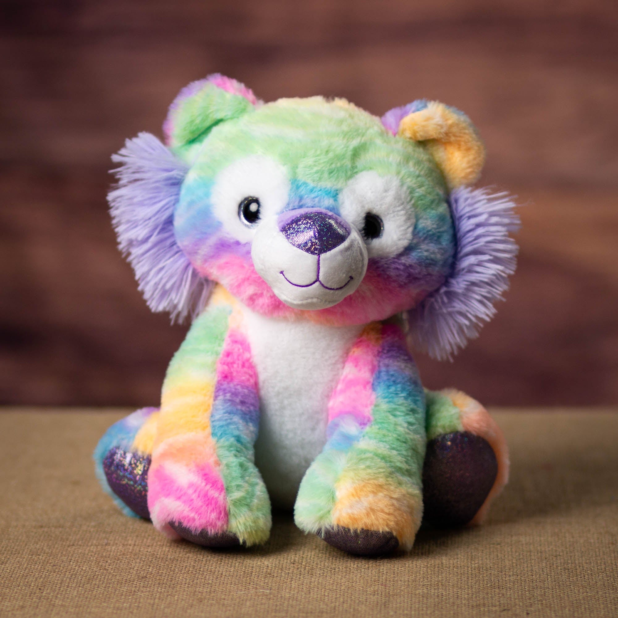 A rainbow lion that is 10 inches tall while sitting