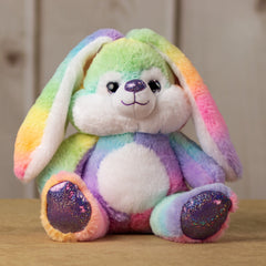 A rainbow rabbit that is 10 inches tall while sitting