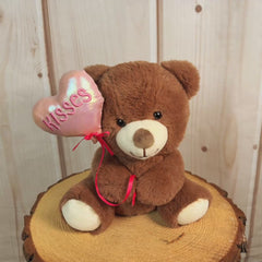 9 inch lbrown stuffed bear holding a balloon that says "kisses"