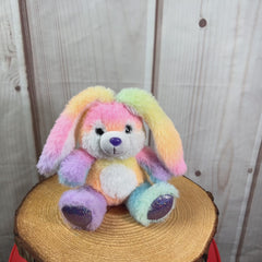 A rainbow rabbit that is 10 inches tall while sitting