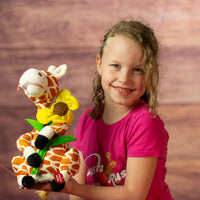 girl holding 12 in stuffed singing giraffe holding a flower