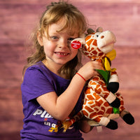 girl holding 12 in stuffed singing giraffe holding a flower