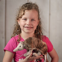 girl holding Stuffed 9" Beige Armadillo with scales