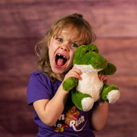 kid holding 7 in stuffed green sitting alligator