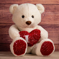 stuffed cream valentines bear holding i love you heart