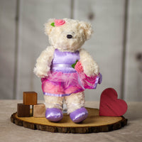 14" stuffed cream ballerina bear wearing a pink and purple leotard and tutu with a pink rose and purple ballet flats