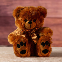 12" brown stuffed bear wearing a gold bow