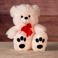 12" white stuffed bear wearing a red bow
