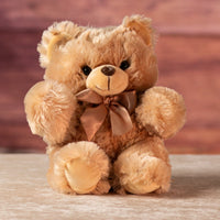 11 in stuffed light brown teddy bear wearing a bow