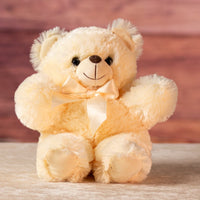 11 in stuffed cream teddy bear wearing a bow