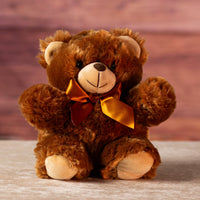 11 in stuffed brown teddy bear wearing a bow