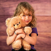 girl holding 11 in stuffed brown teddy bear