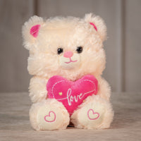 girl holding stuffed 9" cream valentines teddy bear with pink love heart and pink heart paws
