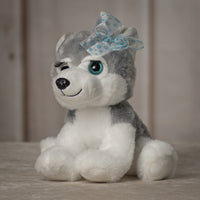 10" stuffed grey huskey with eyelashes and blue eyes wearing a bow