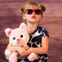 girl holding 10 in stuffed pink wolf with glitter eyes