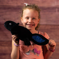 girl holding 10.5 stuffed blue and black axolotl