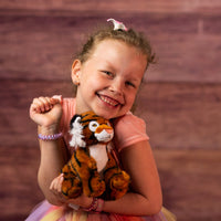 girl holding stufed 6.5 small tiger
