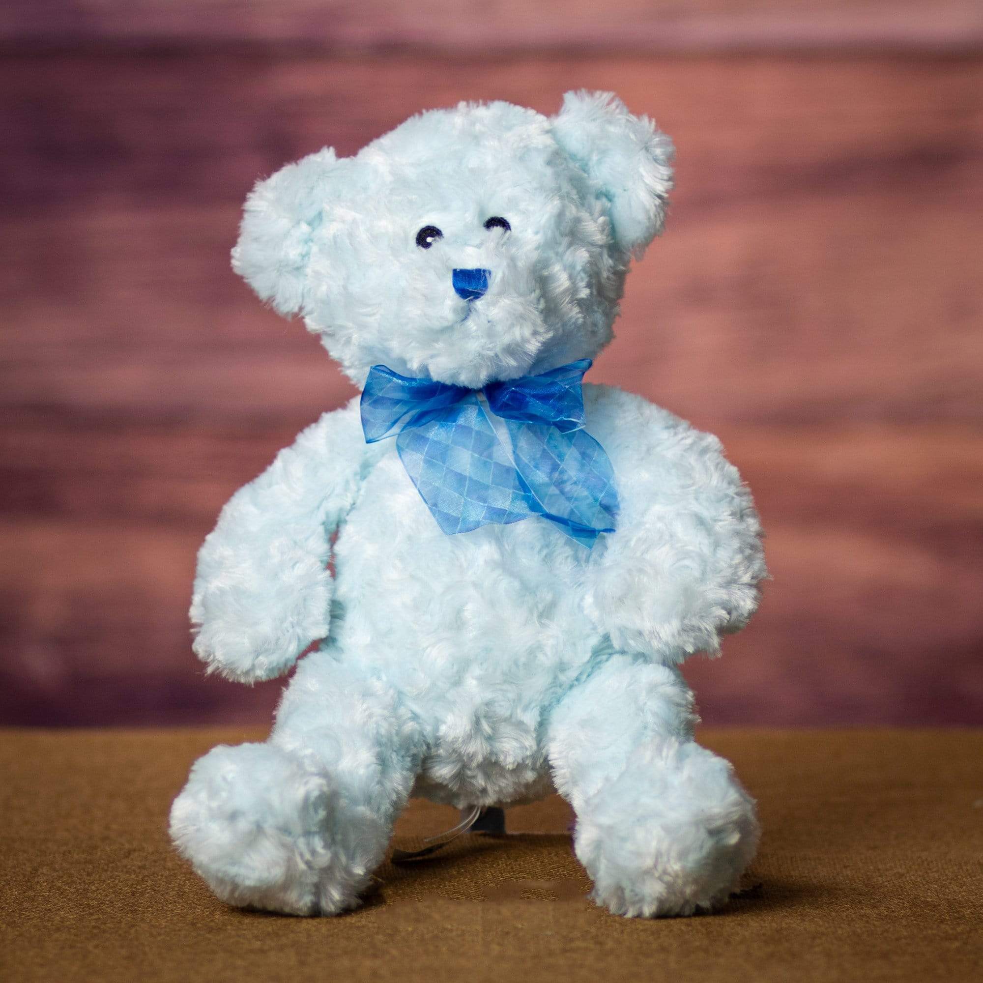 A blue bear that is 14 inches tall while standing