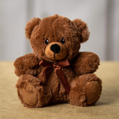 A brown bear that is 6 inches tall while sitting