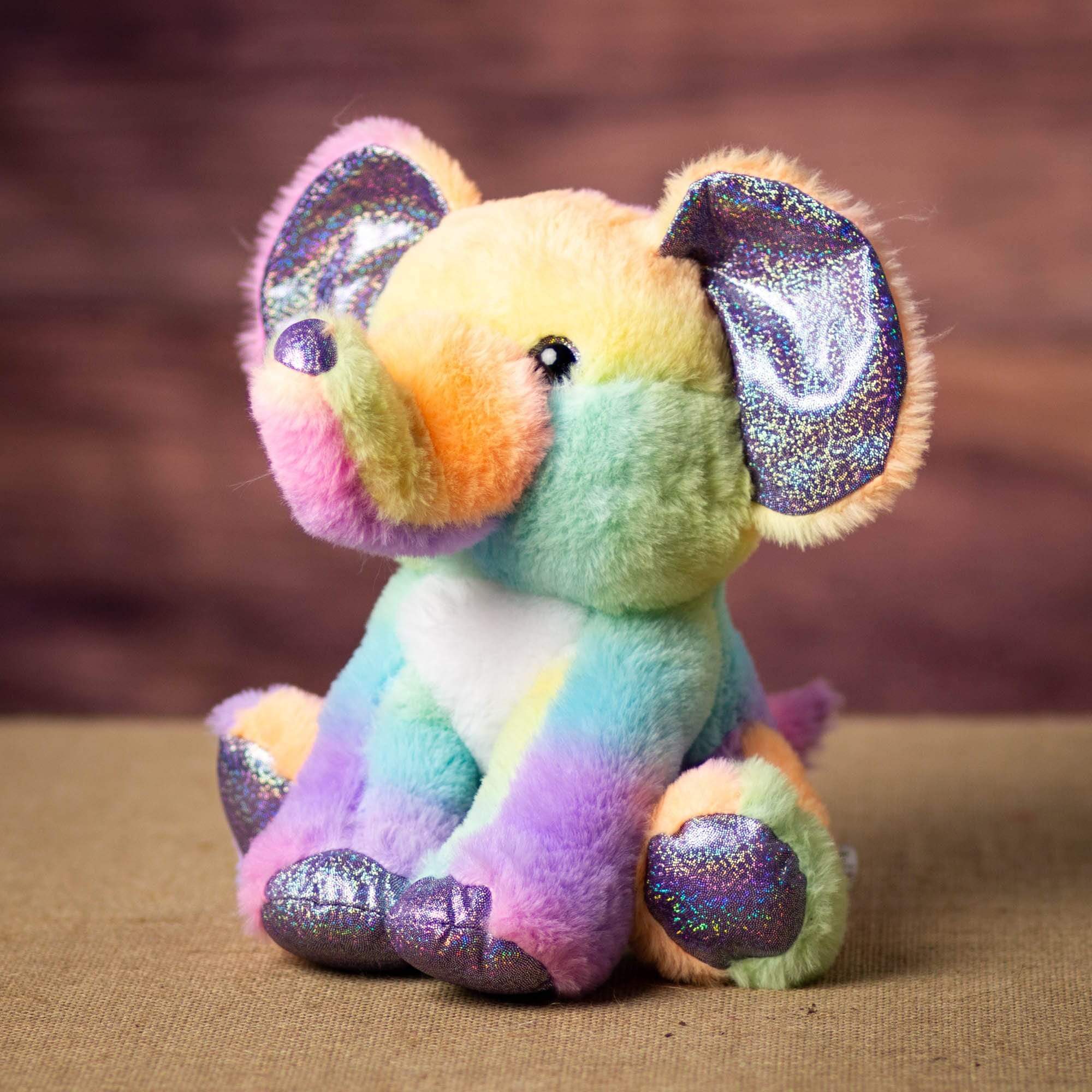 A rainbow elephant that is 10 inches tall while sitting