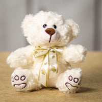 A cream bear that is 7 inches tall while sitting