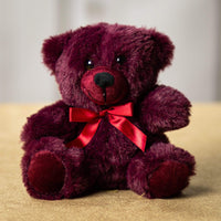 A maroon bear that is 6 inches tall while sitting 