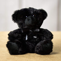 A black bear that is 6 inches tall while sitting