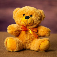A orange bear that is 6 inches tall while sitting 