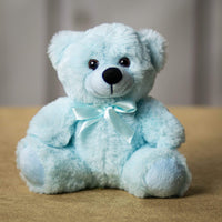 A light blue bear that is 6 inches tall while sitting 