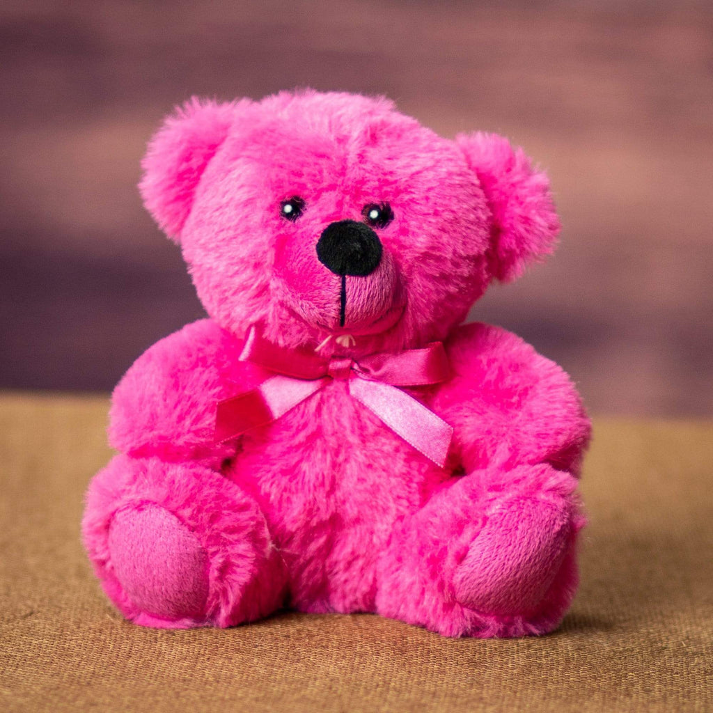 A pink bear that is 6 inches tall while sitting