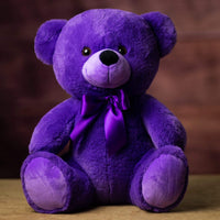 A purple bear that is 14 inches tall while sitting wearing a matching bow