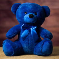A blue bear that is 14 inches tall while sitting wearing a matching bow
