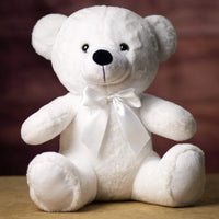 A white bear that is 14 inches tall while sitting wearing a matching bow