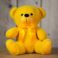 A yellow bear that's 14 inches tall while sitting